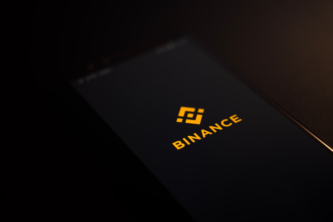Person holding a hardware wallet and smartphone to represent self-custody in cryptocurrency security